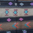 Close-up of the brown Turkish flatweave rug showing traditional details, flatweave construction, wool and cotton and low pile.