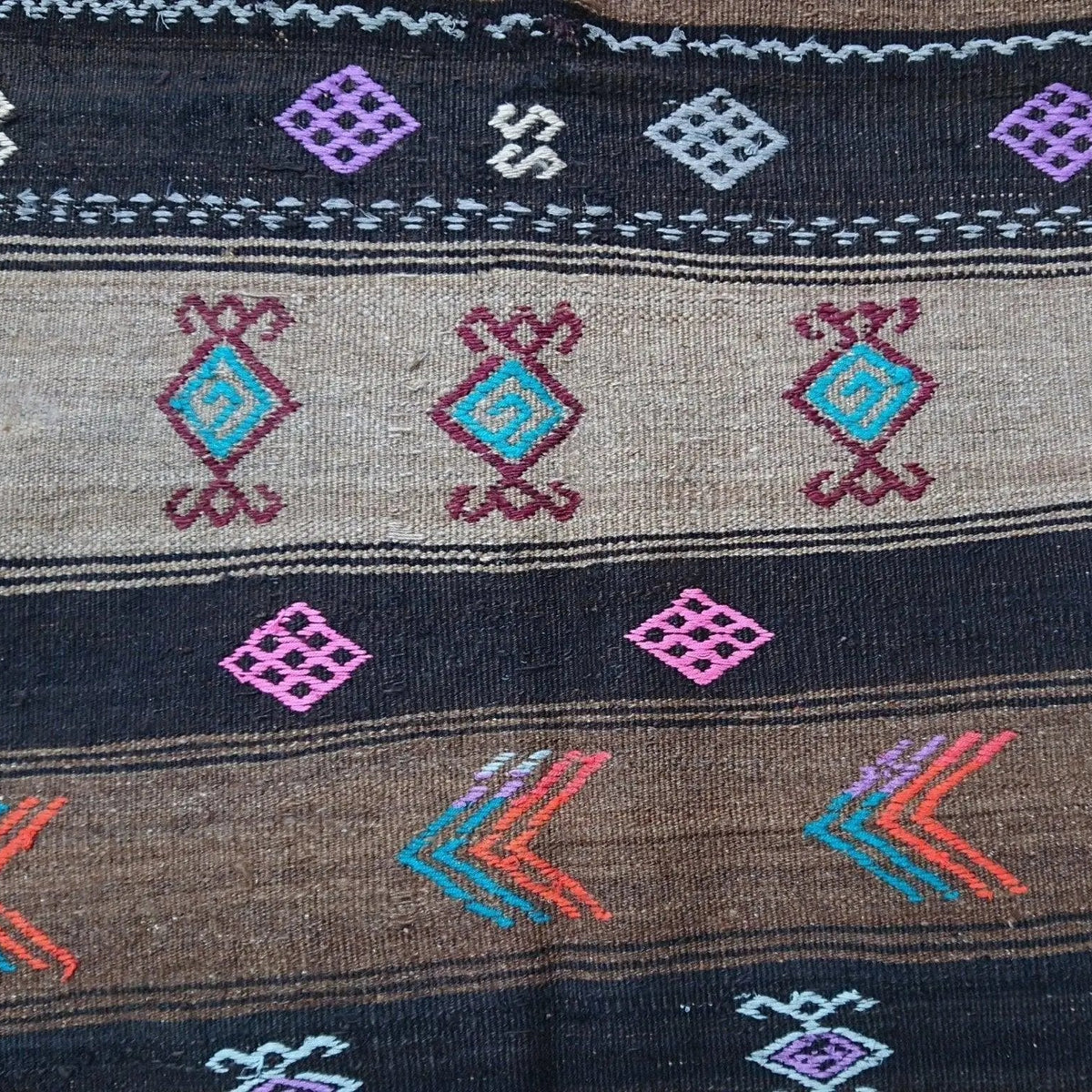 Close-up of the brown Turkish flatweave rug showing traditional details, flatweave construction, wool and cotton and low pile.
