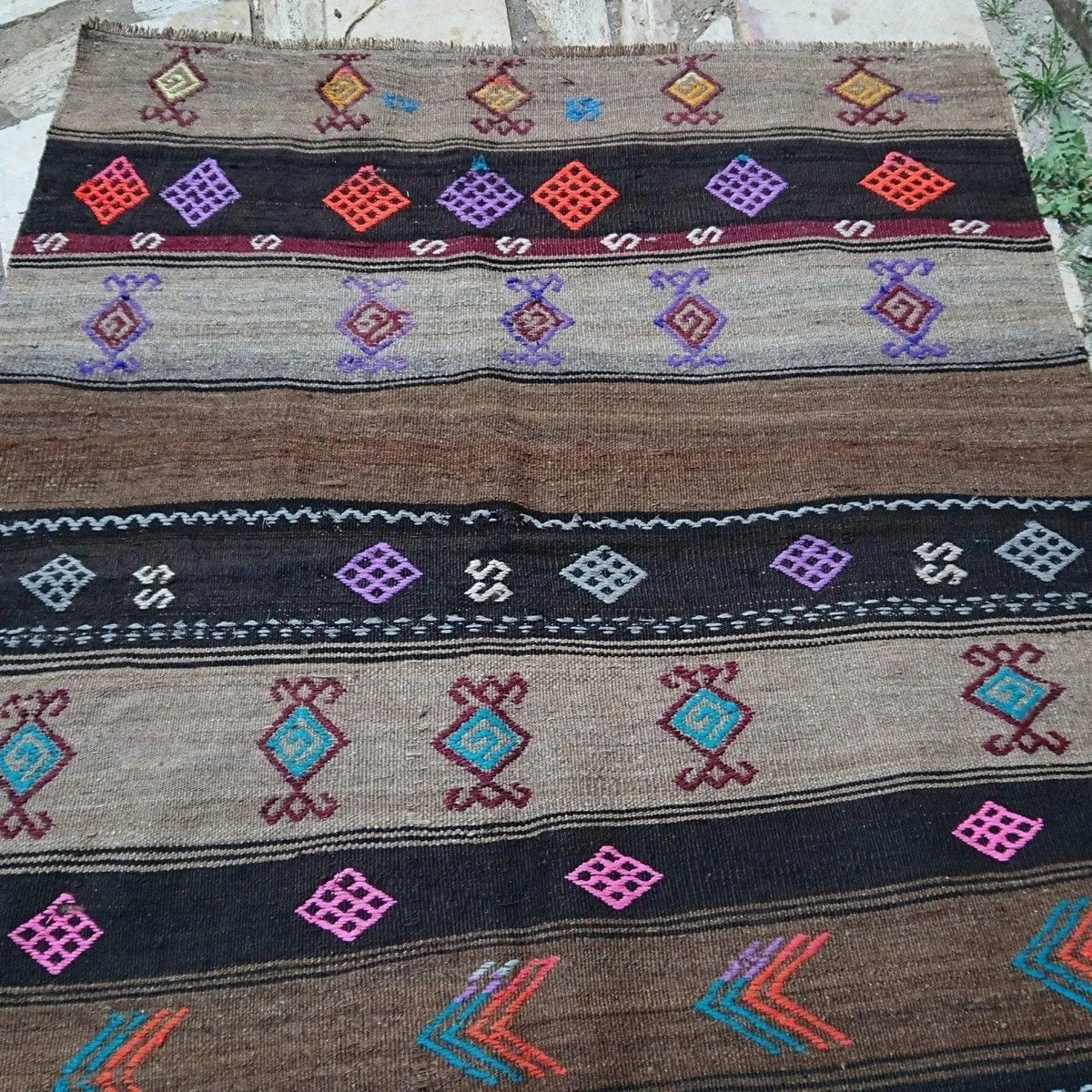 Brown 4' x 5' Turkish flatweave rug in wool and cotton, shown on the floor.