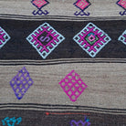 Close-up of the brown Turkish flatweave rug showing traditional details, flatweave construction, wool and cotton and low pile.