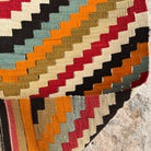Orange 2' x 4' Turkish flatwoven rugs in wool and cotton, shown on the floor.