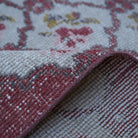 Additional view of the red floral turkish rug, hand-knotted in wool and cotton.