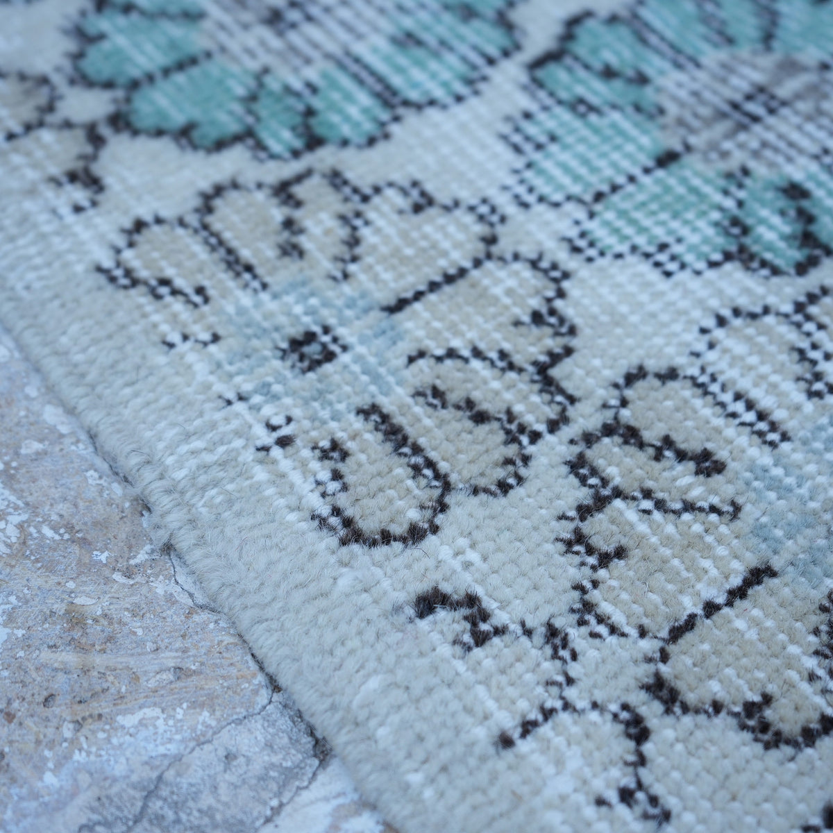 Beige 4' x 6' Turkish floral vintage rug in wool and cotton, shown on the floor.