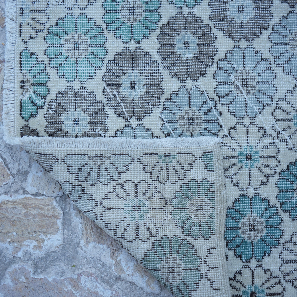 1970s beige Turkish floral vintage rug with floral design, hand-knotted weave and low pile.