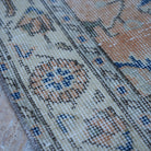Orange 4' x 7' Turkish floral vintage rug in wool and cotton, shown on the floor.