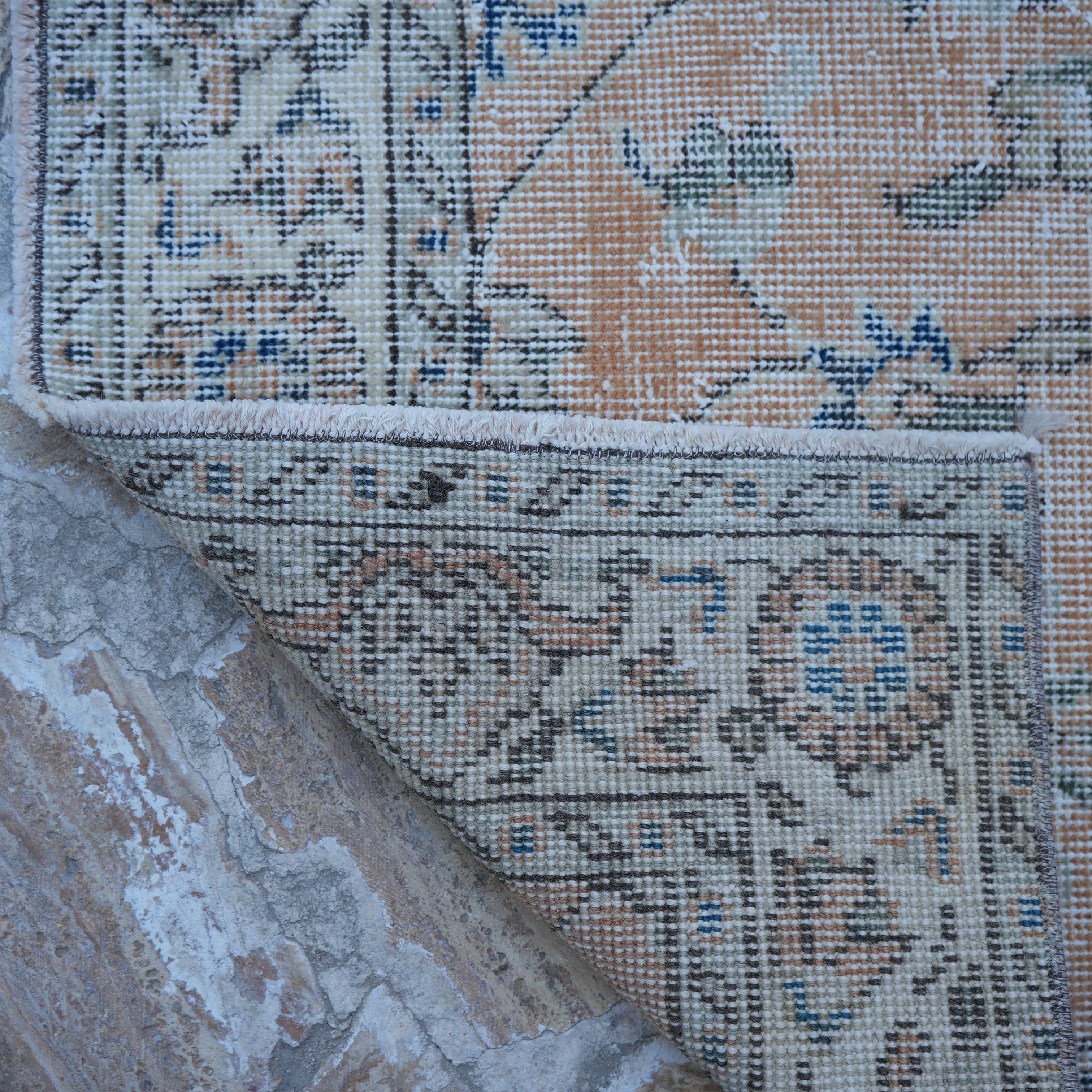 1970s orange Turkish floral vintage rug with floral design, hand-knotted weave and low pile.