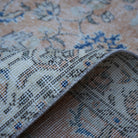Additional view of the orange Turkish floral vintage rug, hand-knotted in wool and cotton.