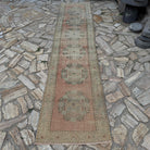 Pale Red 3' x 11' Turkish geometric runner rug in wool and cotton, shown on the floor.