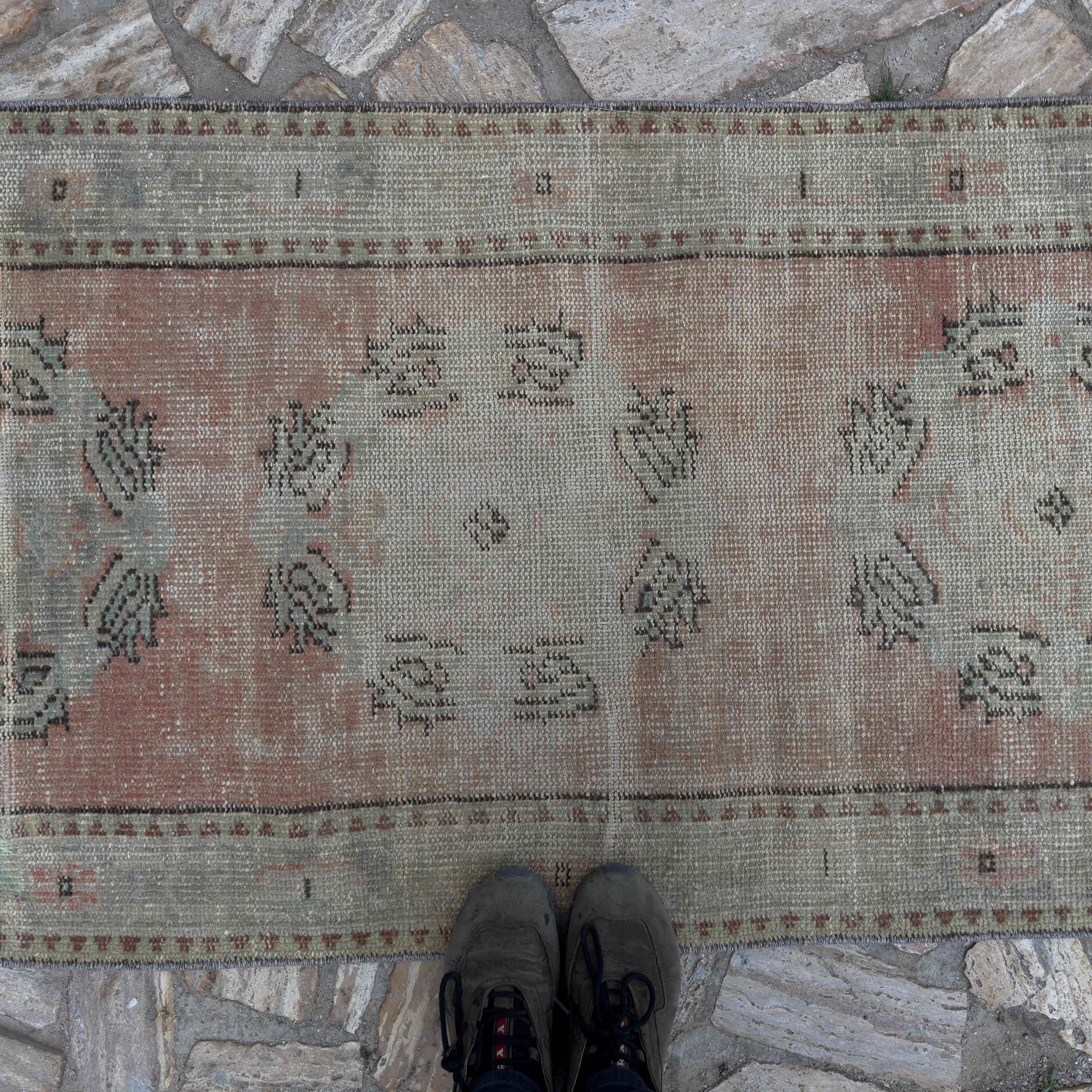 1970s pale red Turkish geometric runner rug with medallion design, hand-knotted weave and low pile.