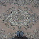 Pink 8' x 12' hand-knotted persian rug in wool and cotton, shown on the floor.