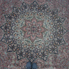 Pink 8' x 13' hand-knotted persian rug in wool and cotton, shown on the floor.