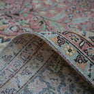 Pink 8' x 13' hand-knotted persian rug from the 1970s with medallion design.