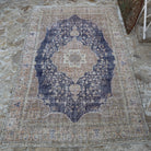Close-up of the blue Turkish hand-knotted vintage rug showing medallion details, hand-knotted weave, wool and cotton and low pile.