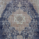 Blue 8' x 12' Turkish hand-knotted vintage rug in wool and cotton, shown on the floor.