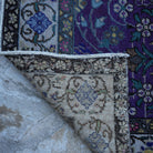 1970s purple Turkish handknotted floral rug with floral design, hand-knotted weave and low pile.