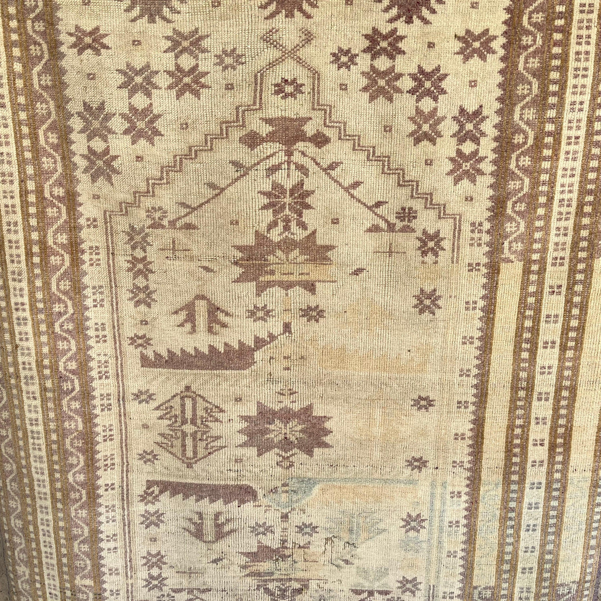 Pink 3' x 6' Turkish handknotted rug in wool and cotton, shown on the floor.