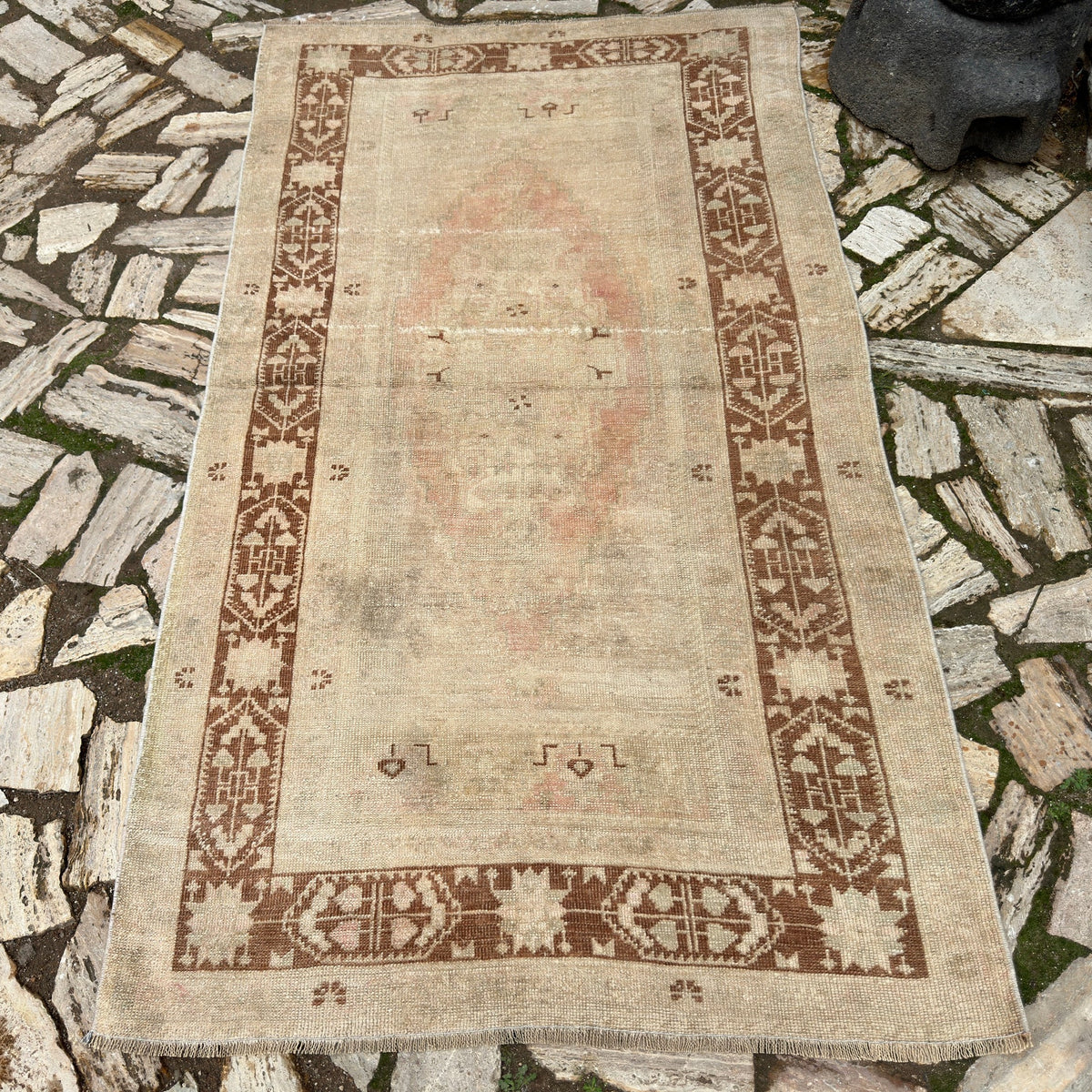 Brown 4' x 7' Turkish handknotted rug in wool and cotton, shown on the floor.
