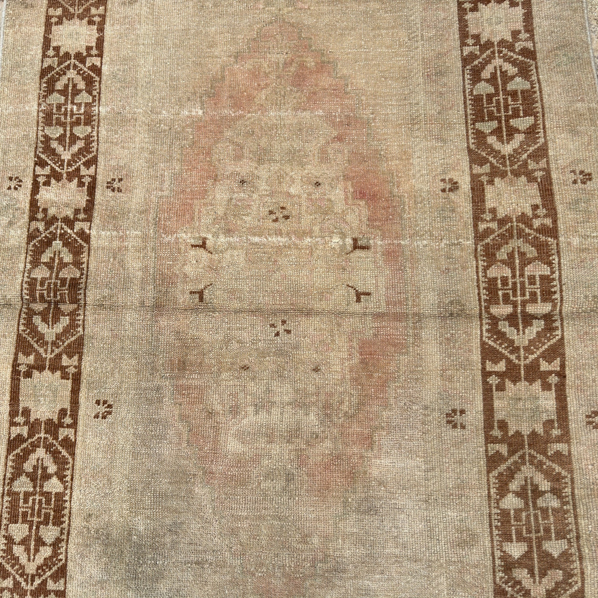 1970s brown Turkish handknotted rug with traditional design, hand-knotted weave and low pile.
