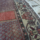 Close-up of the red Turkish handknotted rug showing medallion details, hand-knotted weave, wool and cotton and low pile.