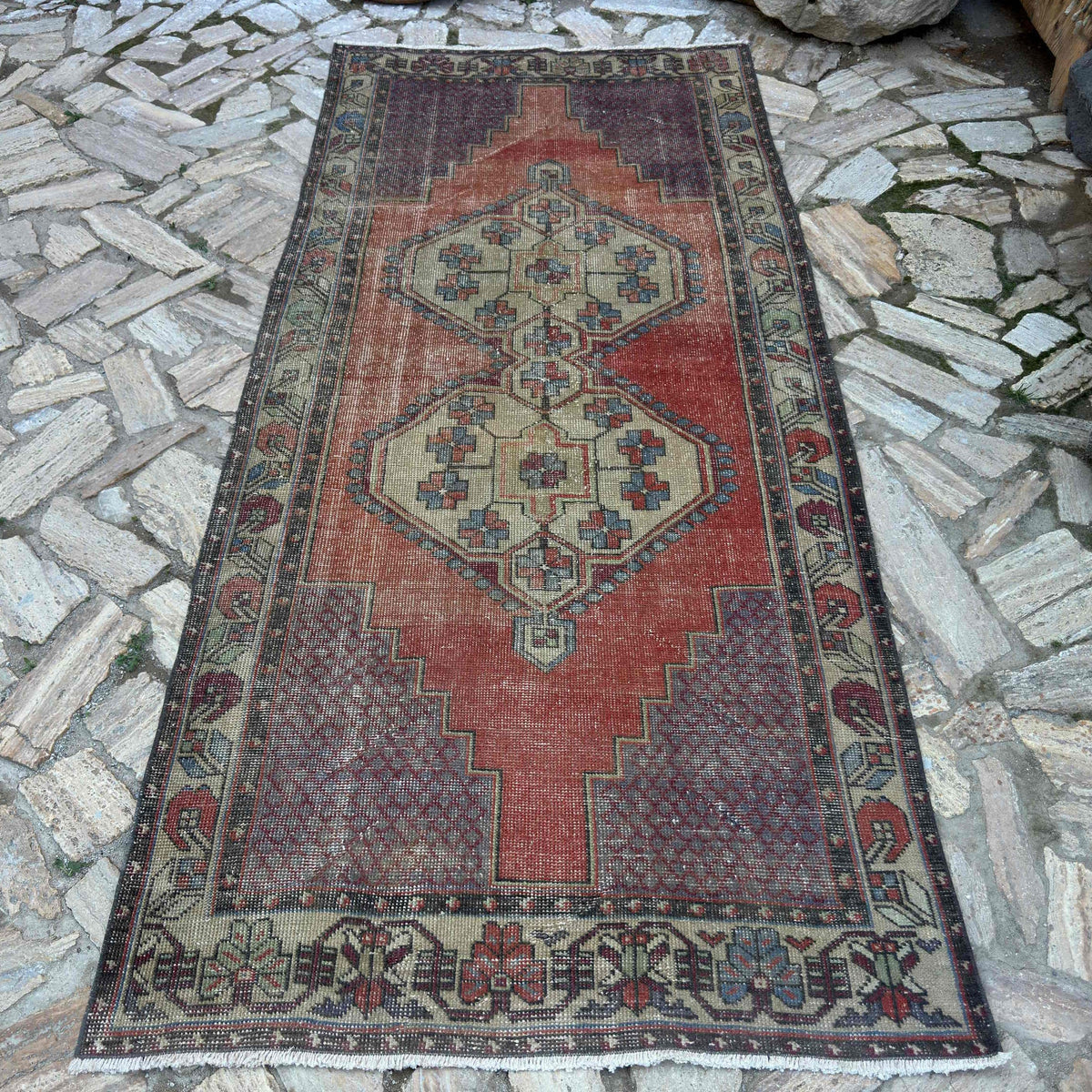 Red 4' x 9' Turkish handknotted rug in wool and cotton, shown on the floor.