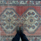 1970s red Turkish handknotted rug with medallion design, hand-knotted weave and low pile.