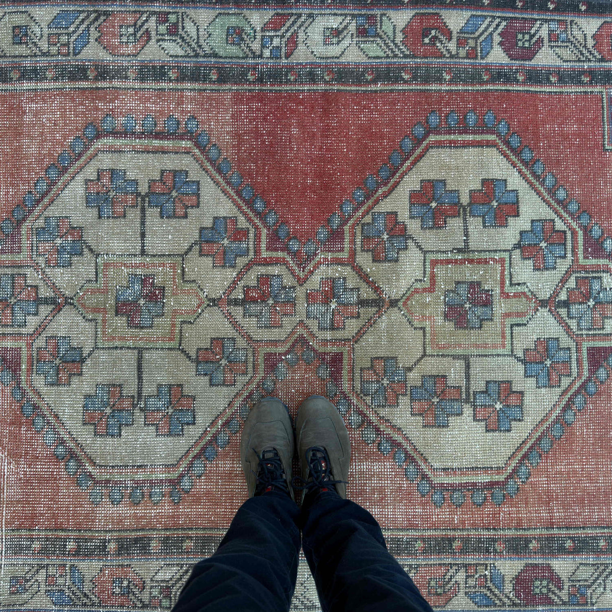1970s red Turkish handknotted rug with medallion design, hand-knotted weave and low pile.