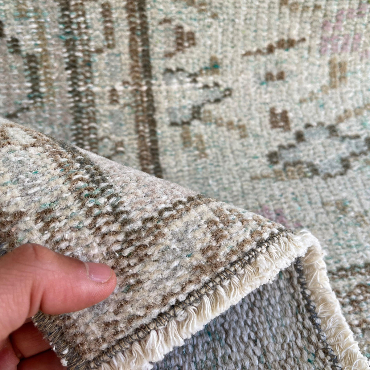 Pale Green 5' x 8' Turkish handknotted rug in wool and cotton, shown on the floor.