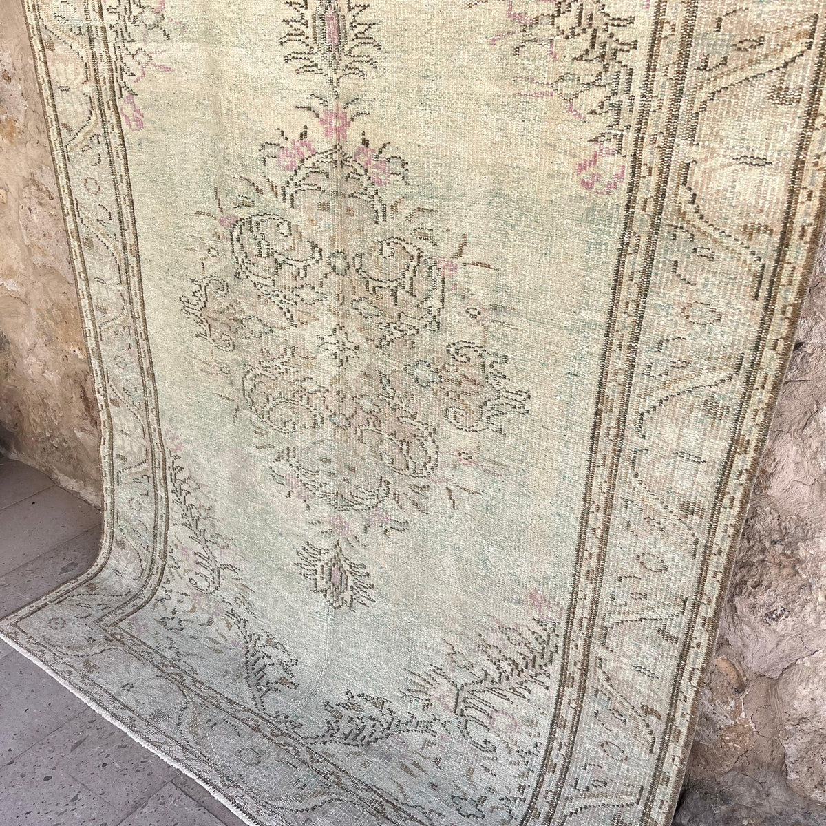 1970s pale green Turkish handknotted rug with medallion design, hand-knotted weave and low pile.