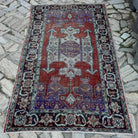 Purple 5' x 8' Turkish handknotted rug in wool and cotton, shown on the floor.
