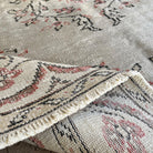 Close-up of the pale green Turkish handknotted rug showing medallion details, hand-knotted weave, wool and cotton and low pile.