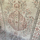 Pale Green 5' x 9' Turkish handknotted rug in wool and cotton, shown on the floor.