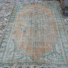 Orange 6' x 9' Turkish handknotted rug in wool and cotton, shown on the floor.