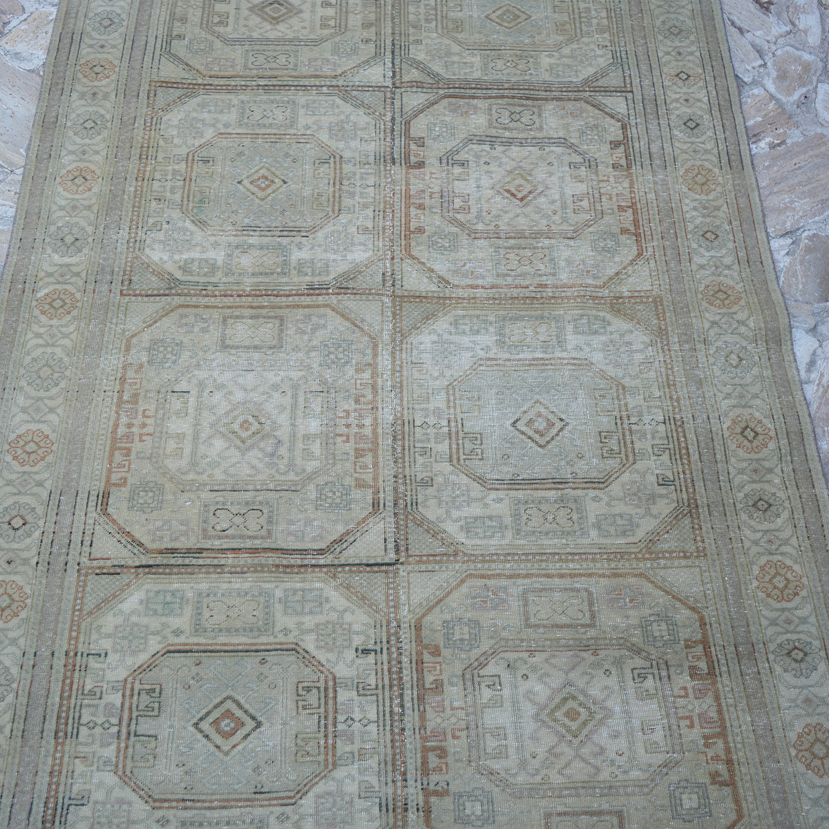 Close-up of the beige Turkish handknotted vintage rug showing neutral details, hand-knotted weave, wool and cotton and low pile.