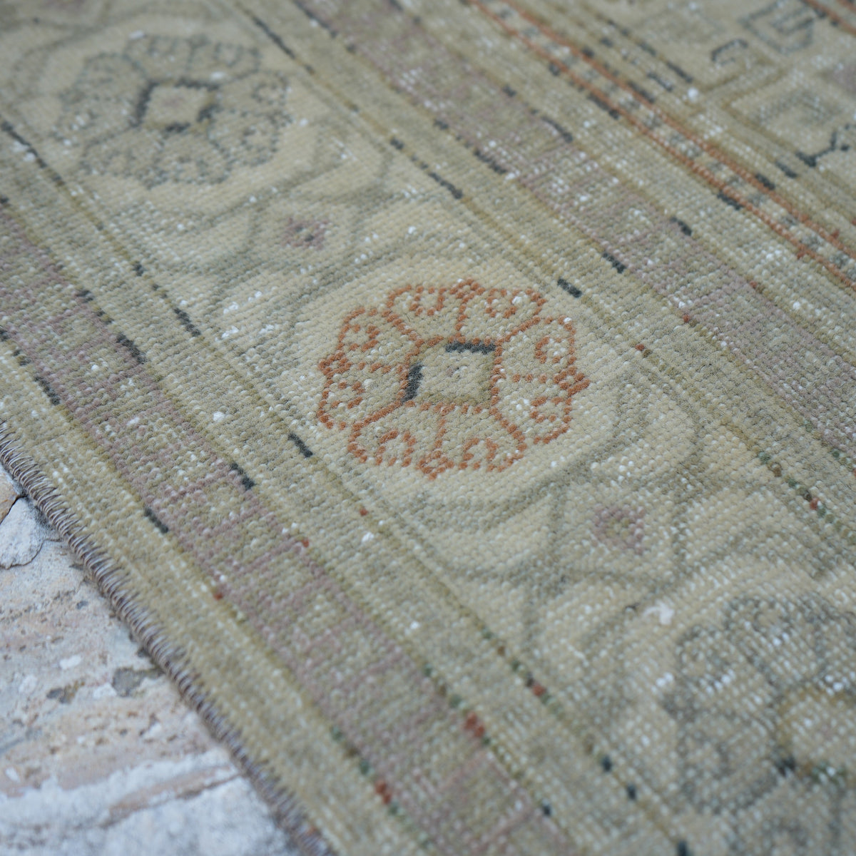 Beige 5' x 8' Turkish handknotted vintage rug in wool and cotton, shown on the floor.