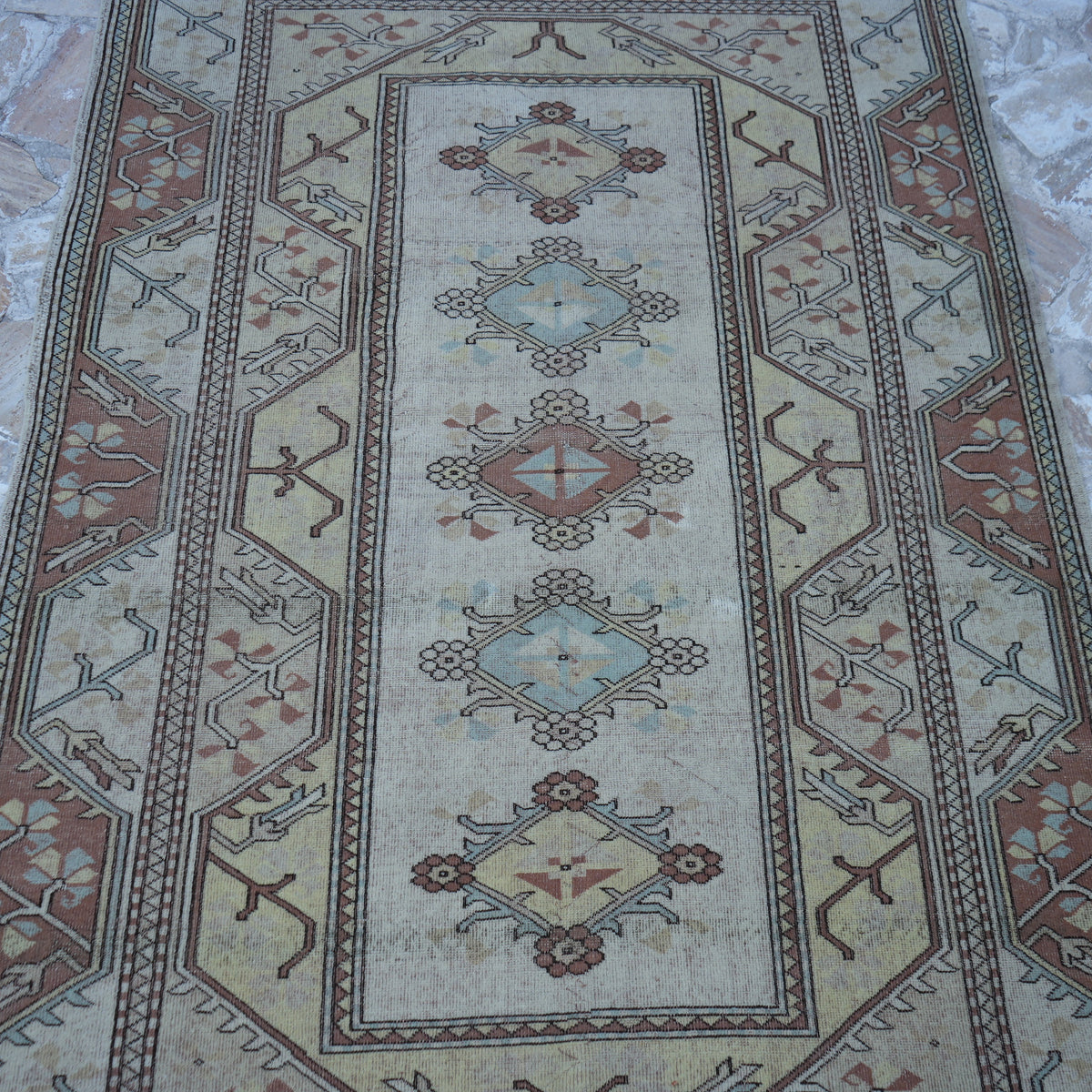 Close-up of the beige Turkish handknotted wool rug showing traditional details, hand-knotted weave, wool and low pile.