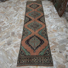 Orange 3' x 12' Turkish handmade oushak runner rug in wool, shown on the floor.
