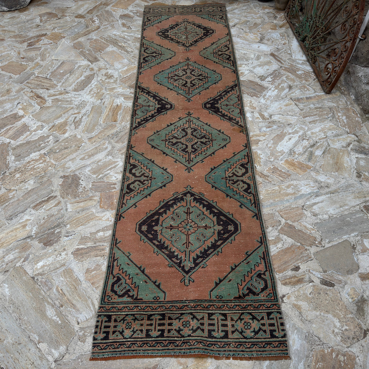 Orange 3' x 12' Turkish handmade oushak runner rug in wool, shown on the floor.
