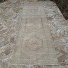 Beige 3' x 10' Turkish handmade runner rug in wool and cotton, shown on the floor.