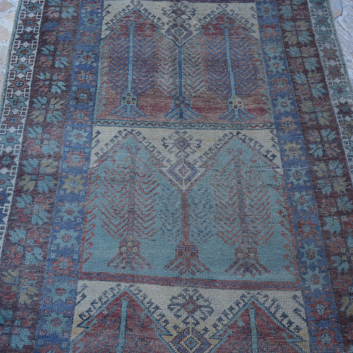 Close-up of the colorful Turkish handmade vintage carpet showing traditional details, hand-knotted weave, wool and low pile.