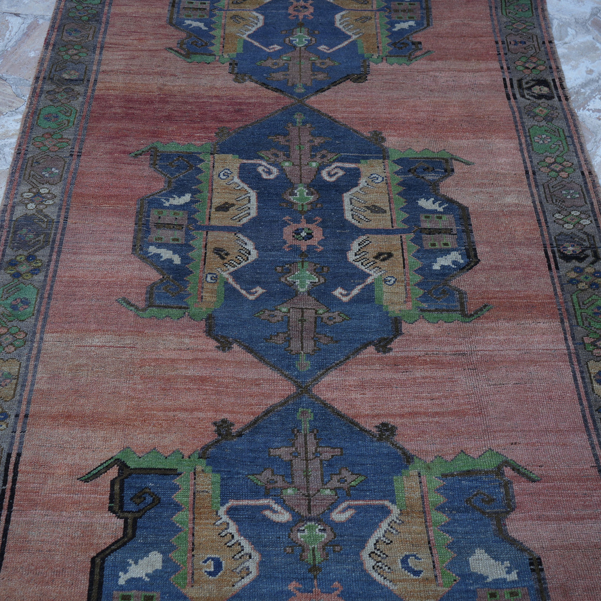 Close-up of the red Turkish handmade vintage rug showing traditional details, hand-knotted weave, wool and low pile.
