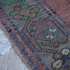 Red 6' x 11' Turkish handmade vintage rug in wool, shown on the floor.