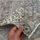 Close-up of the blue Turkish handmade vintage wool rug showing geometric details, hand-knotted weave, wool and cotton and low pile.