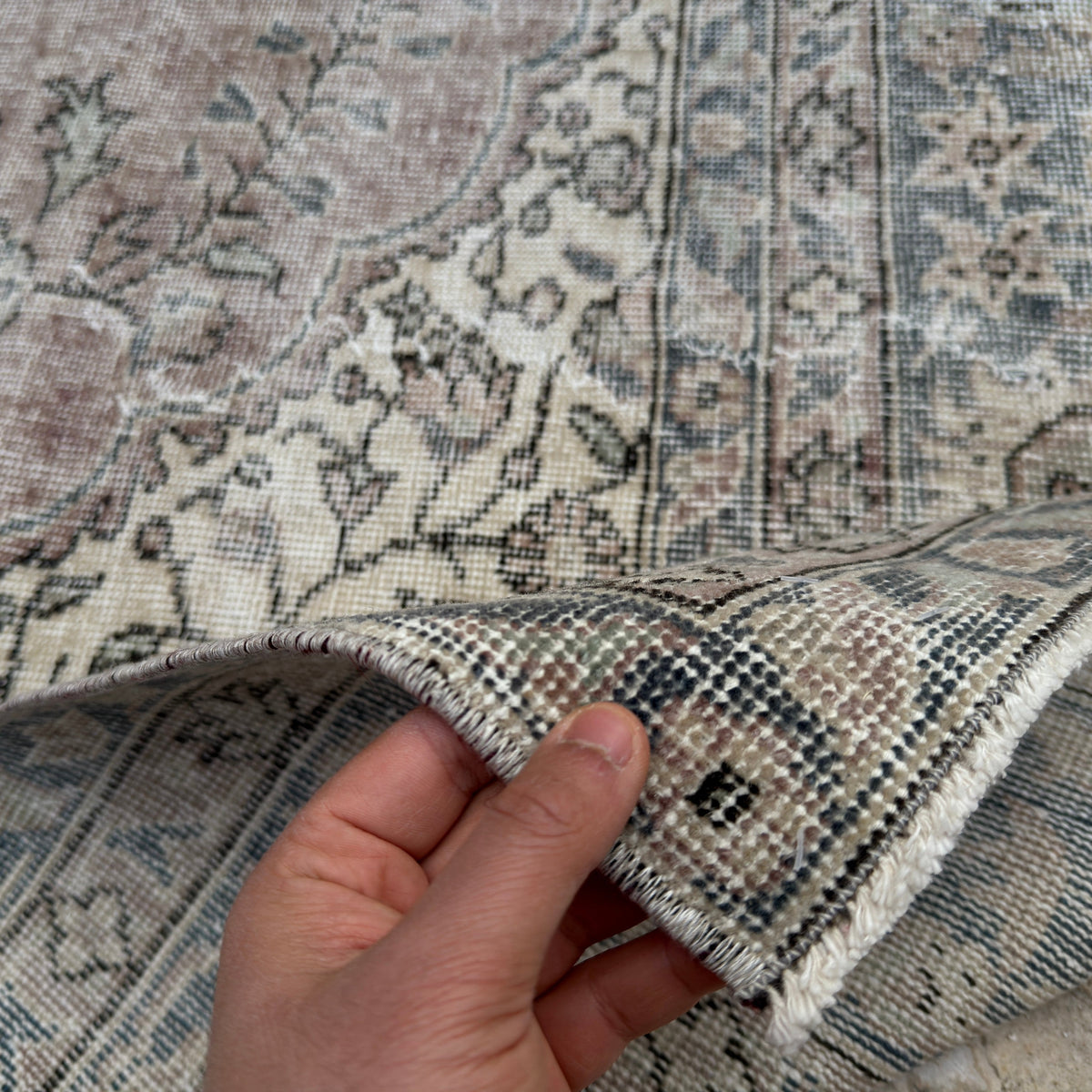 Close-up of the blue Turkish handmade vintage wool rug showing geometric details, hand-knotted weave, wool and cotton and low pile.