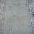 Close-up of the beige Turkish handwoven runner rug showing traditional details, hand-knotted weave, wool and cotton and low pile.