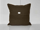 Close-up of the beige Turkish kilim pillow showing geometric details.
