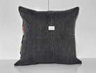 Close-up of the black Turkish kilim pillow showing traditional details, low pile.