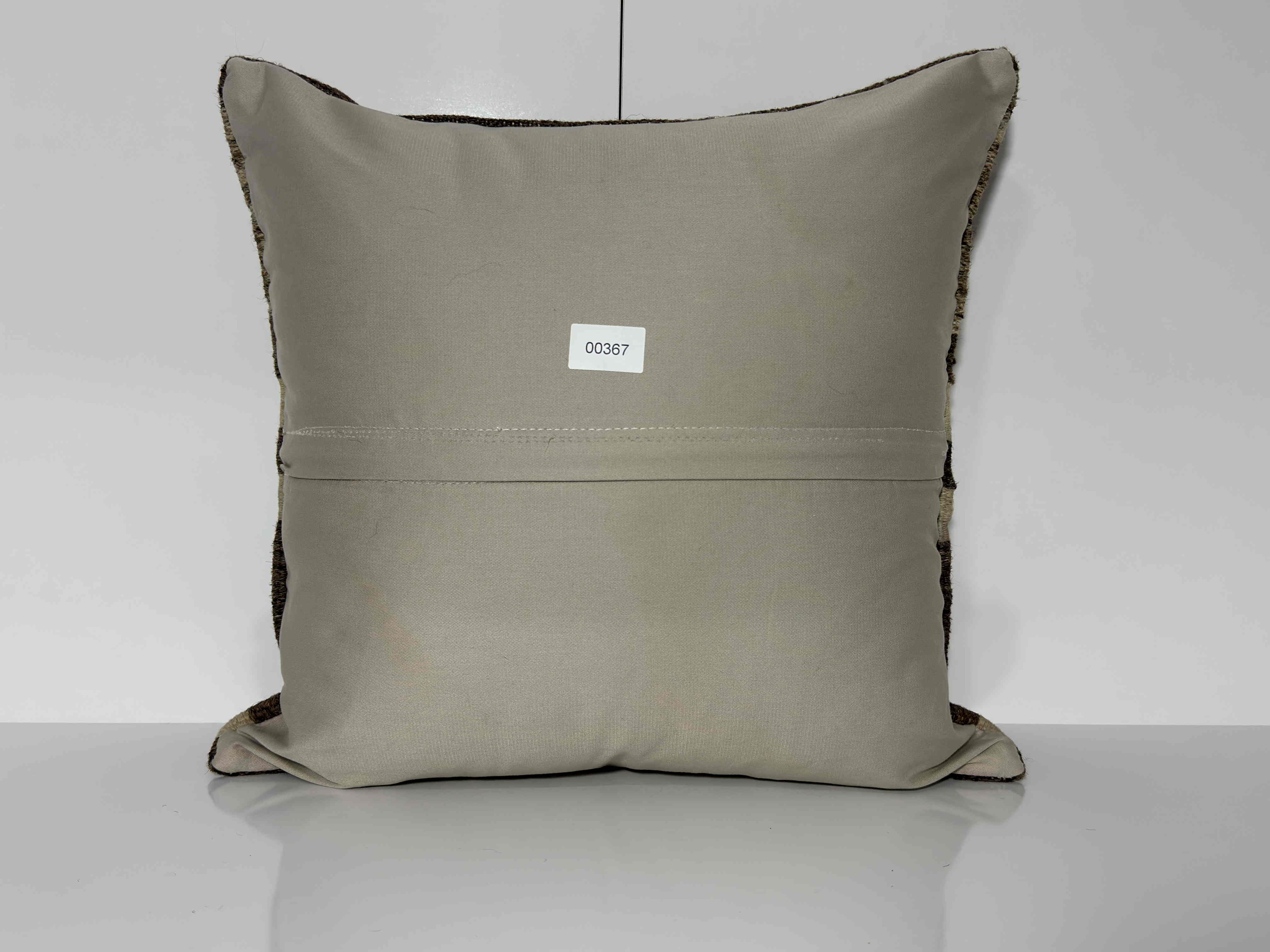 Close-up of the brown Turkish kilim pillow showing striped details.