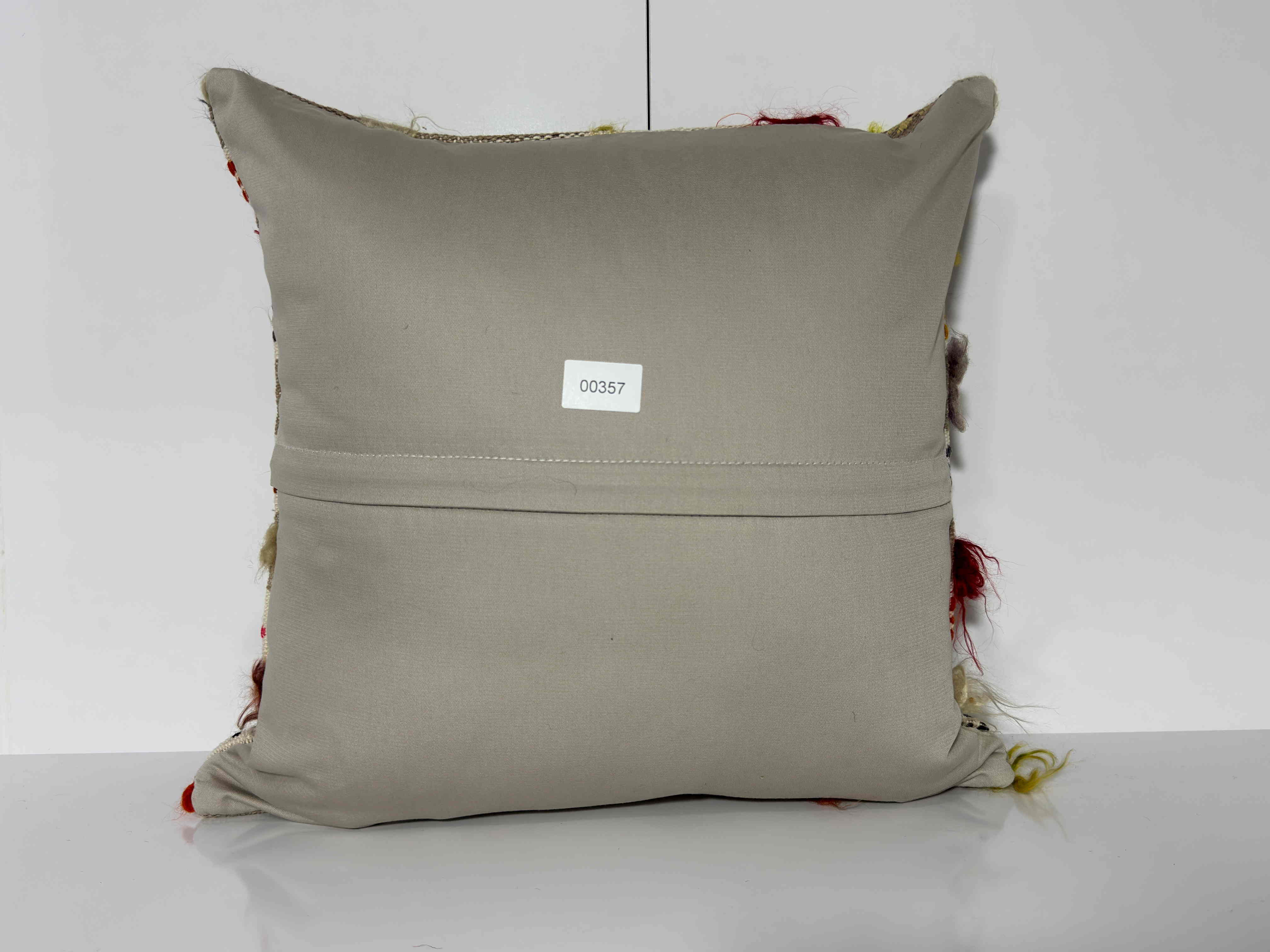 Close-up of the gray Turkish kilim pillow showing striped details.
