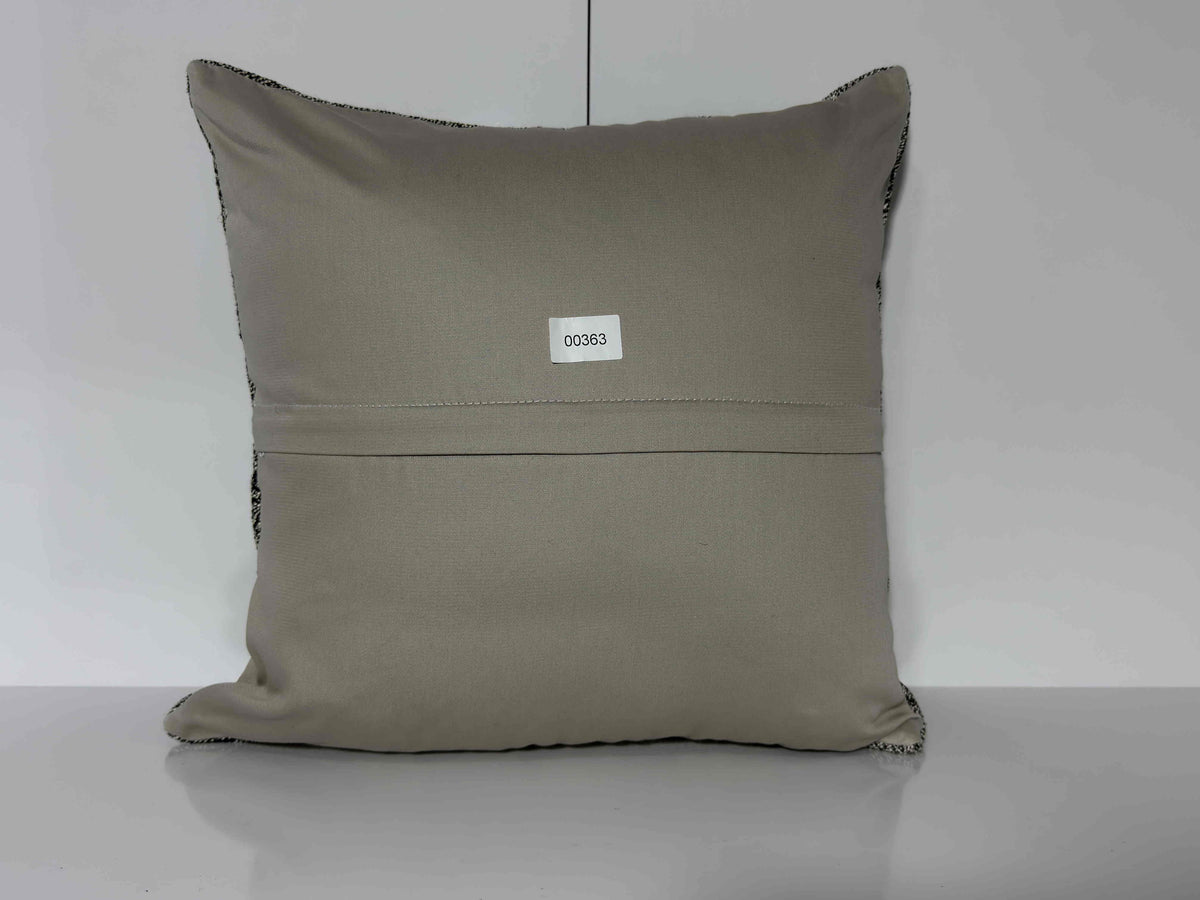 Close-up of the gray Turkish kilim pillow showing traditional details.