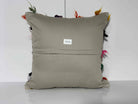 Close-up of the white Turkish kilim pillow showing traditional details.